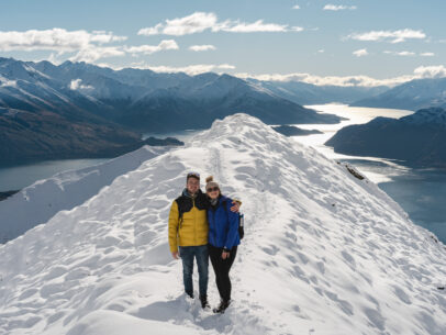 Couple looking at camera at Roy's Peak Lookout. Wanaka, Otago Region, New Zealand